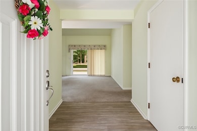 Hall with baseboards and wood finished floors