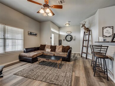Living room with ceiling fan and hardwood / wood-s