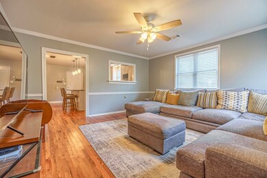 Living room with light wood-type flooring, ceiling