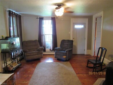 Living Room with hardwood floors and wood stove. T