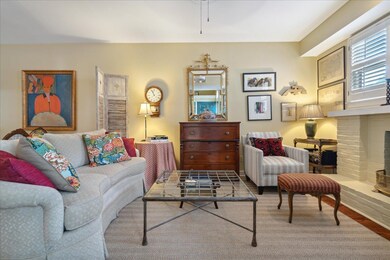 Living room with a fireplace and wood-type floorin