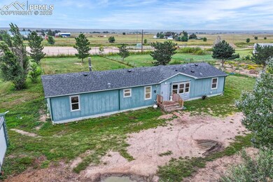 View of front facade featuring a view of rural / pastoral area, front lawn area and round about with plenty of parking.