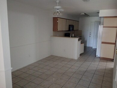 Kitchen with sink, ceiling fan, white fridge, and 