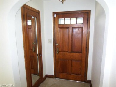 Foyer with front door and guest closet.