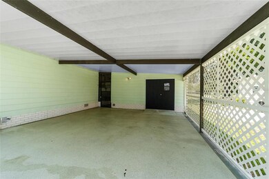 Spacious 2 Car Carport with PAINTED FLOOR, BREEZEWAY (L) and ENCLOSED GOLF CART GARAGE (R).