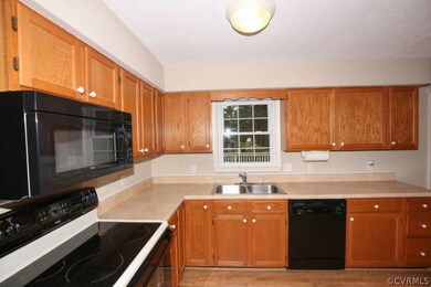 Kitchen Window looks over Deck and into Backyard.