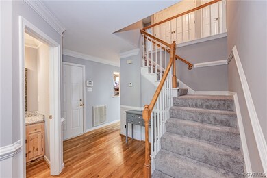 Staircase featuring light hardwood floors and orna