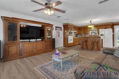 Living room featuring light wood-style flooring and a ceiling fan