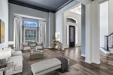 Foyer featuring a towering ceiling, dark wood-sty