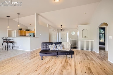 Living room with baseboards, light wood-style floo