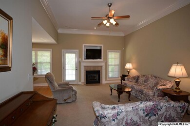 Features 10' ceilings w/crown molding, fan, and gas-log fireplace.