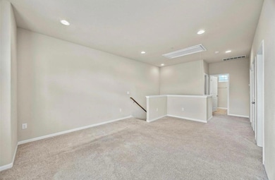 Empty room with light colored carpet, baseboards,