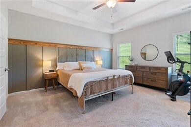 Bedroom featuring carpet floors, multiple windows,