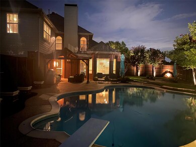 Pool at dusk featuring illuminated by gorgeous landscape lighting.
