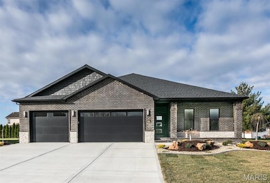 View of front of home with a garage and a front yard