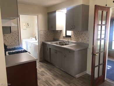 Living room with ceiling fan and dark wood-type flooring