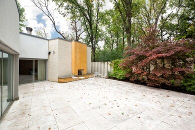 Private patio that includes fireplace and built-in