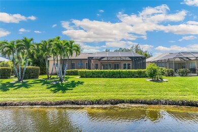 Rear view of property with a yard, a water view, a