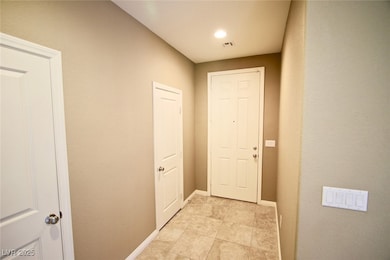 Entryway featuring light tile patterned floors and