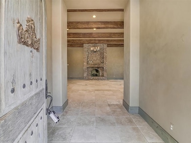 Hall featuring light tile floors, beamed ceiling, 