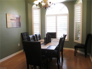 Formal dining room with hardwood floors and plantation shutters