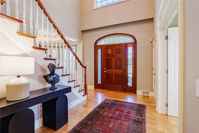 Elegant Mahogany entry door opens up to a soaring two story foyer!