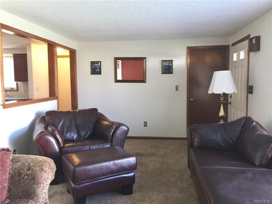 Living room opens to the kitchen and has newer car