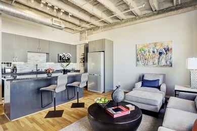 The open living/dining room featuring motorized bl
