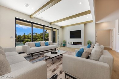 Living area featuring light wood-style floors, bea