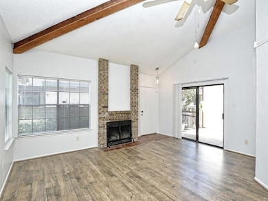 Unfurnished living room featuring beamed ceiling,