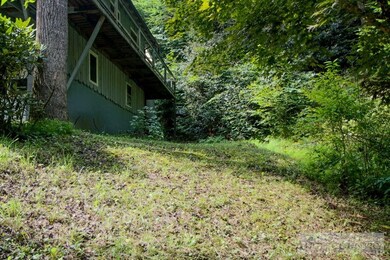Side Yard: The deck runs around the side of the home.