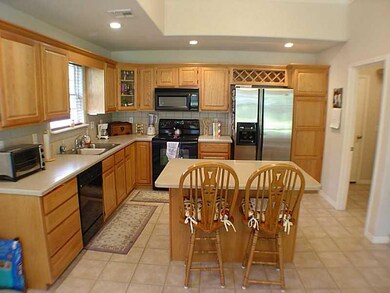 Kitchen. Beautiful Island, Tile Floors, and Bar Stools Stay