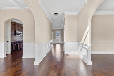 Entrance foyer featuring dark wood-style flooring,