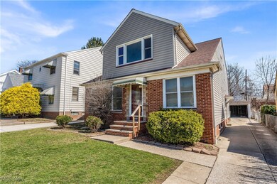 View of front of house with concrete driveway and a front lawn