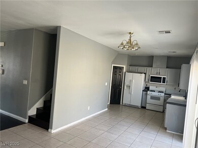 Kitchen featuring white appliances, a sink, light