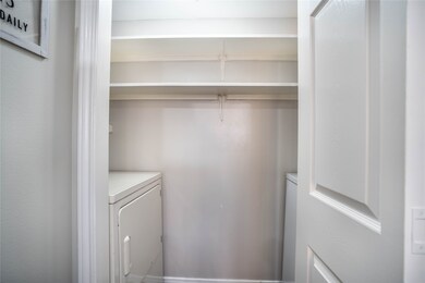 Utility room is equipped with a full-size washer a