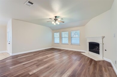 Unfurnished living room with ceiling fan, hardwood