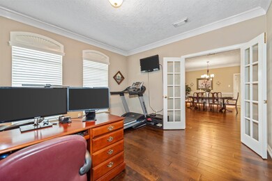 The study is to the right of the entry hall with double French door entry