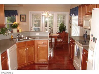Kitchen - Kitchen leads to breakfast area then out