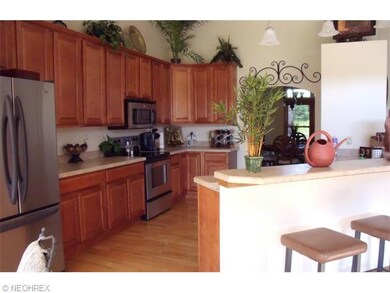 Open kitchen with hardwood floors, breakfast bar