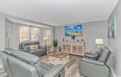 Living room with light hardwood / wood-style floor