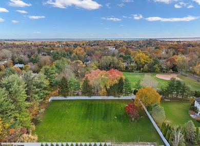 Photo virtually altered to represent rendering of land without existing structures currently present on property