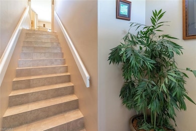 Stairway featuring tile patterned floors