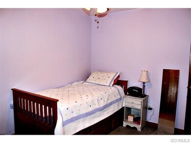 One of the two first floor bedrooms with wall to w