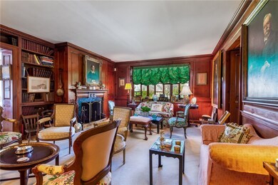 Paneled sitting room with fireplace.