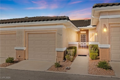 Home with a tiled roof, concrete driveway, and stu