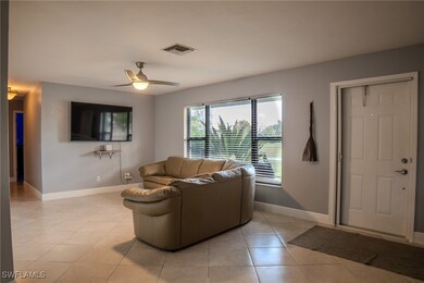 Tiled living room with ceiling fan