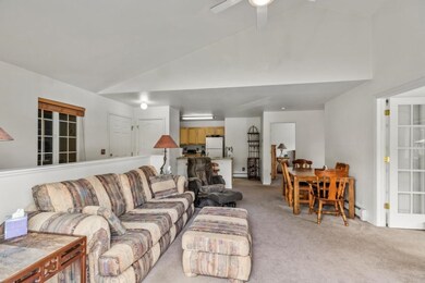 Living room with baseboard heating, light colored