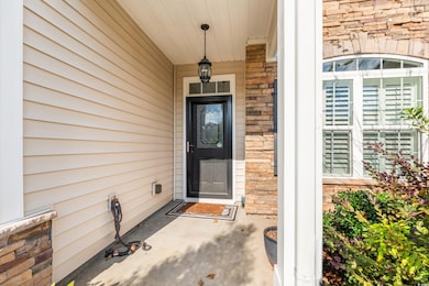 View of exterior entry featuring stone siding