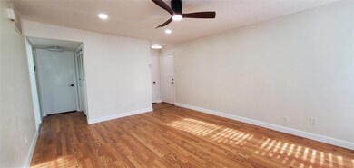 Spare room with ceiling fan and hardwood / wood-st